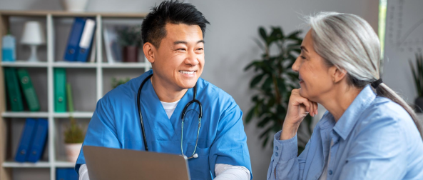 Healthcare provider in scrubs consulting with a patient in a medical office